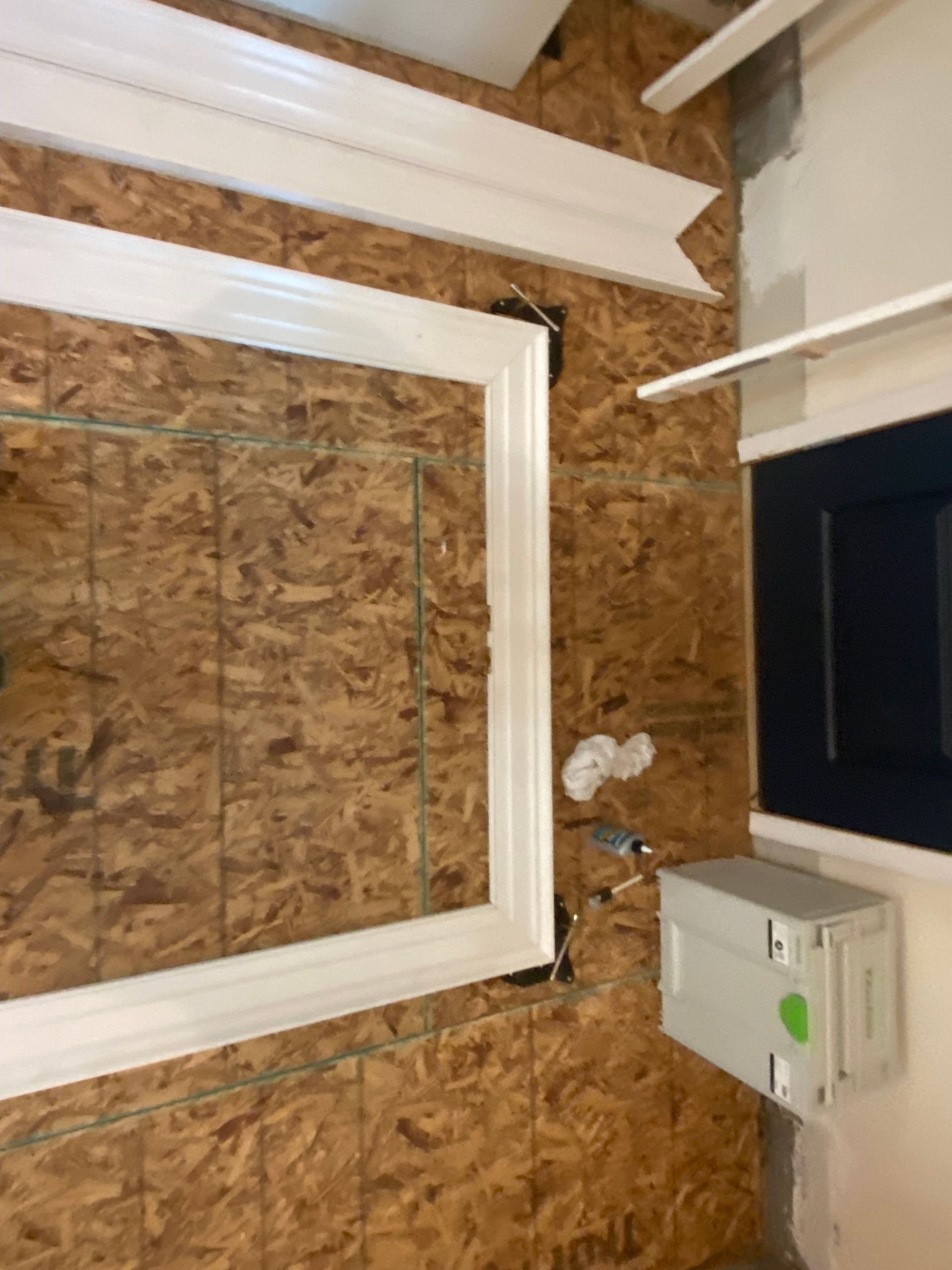 A picture frame is hanging on a wooden wall