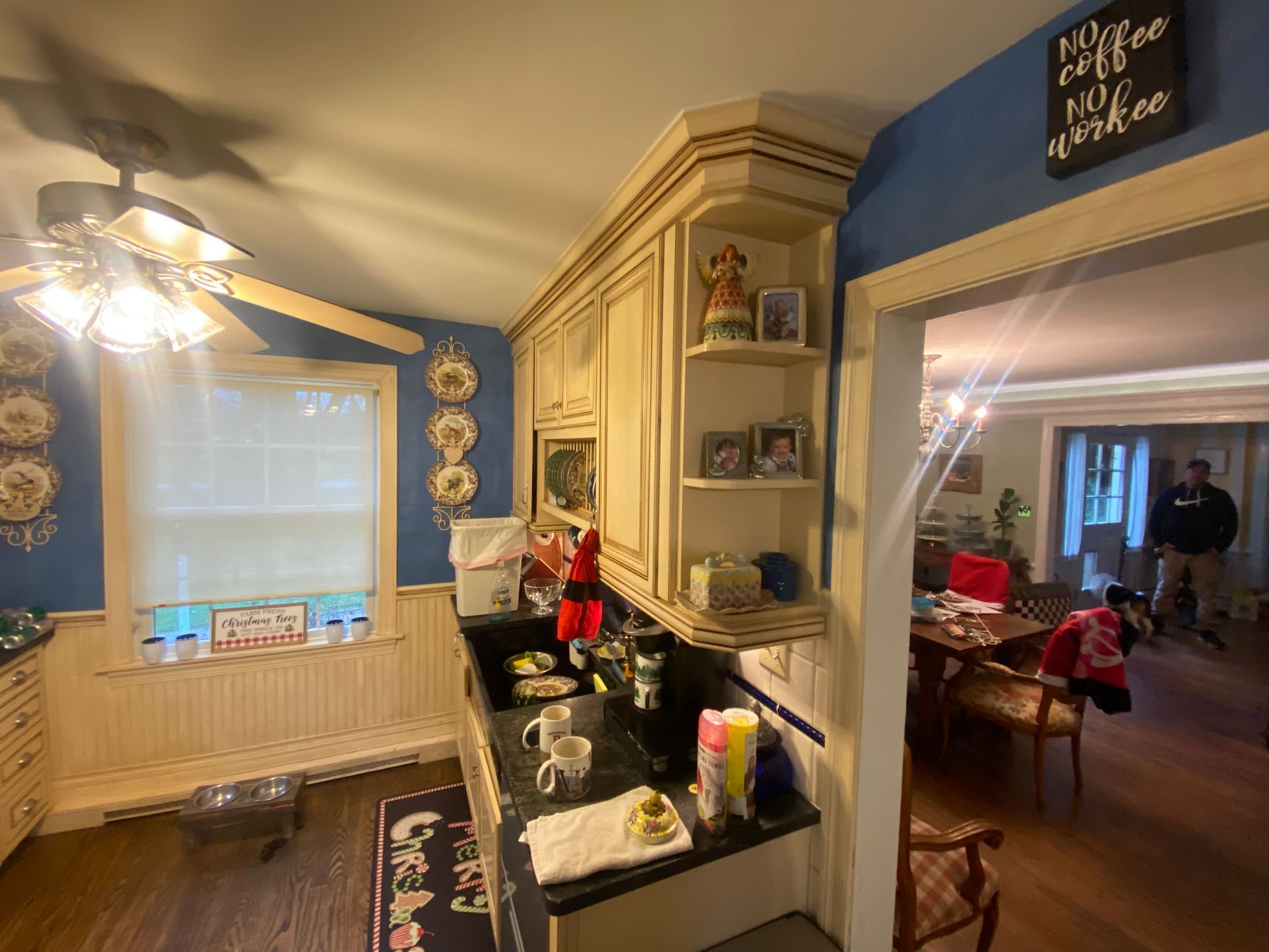 A kitchen with a ceiling fan and a sign that says `` my coffee my medicine ''.