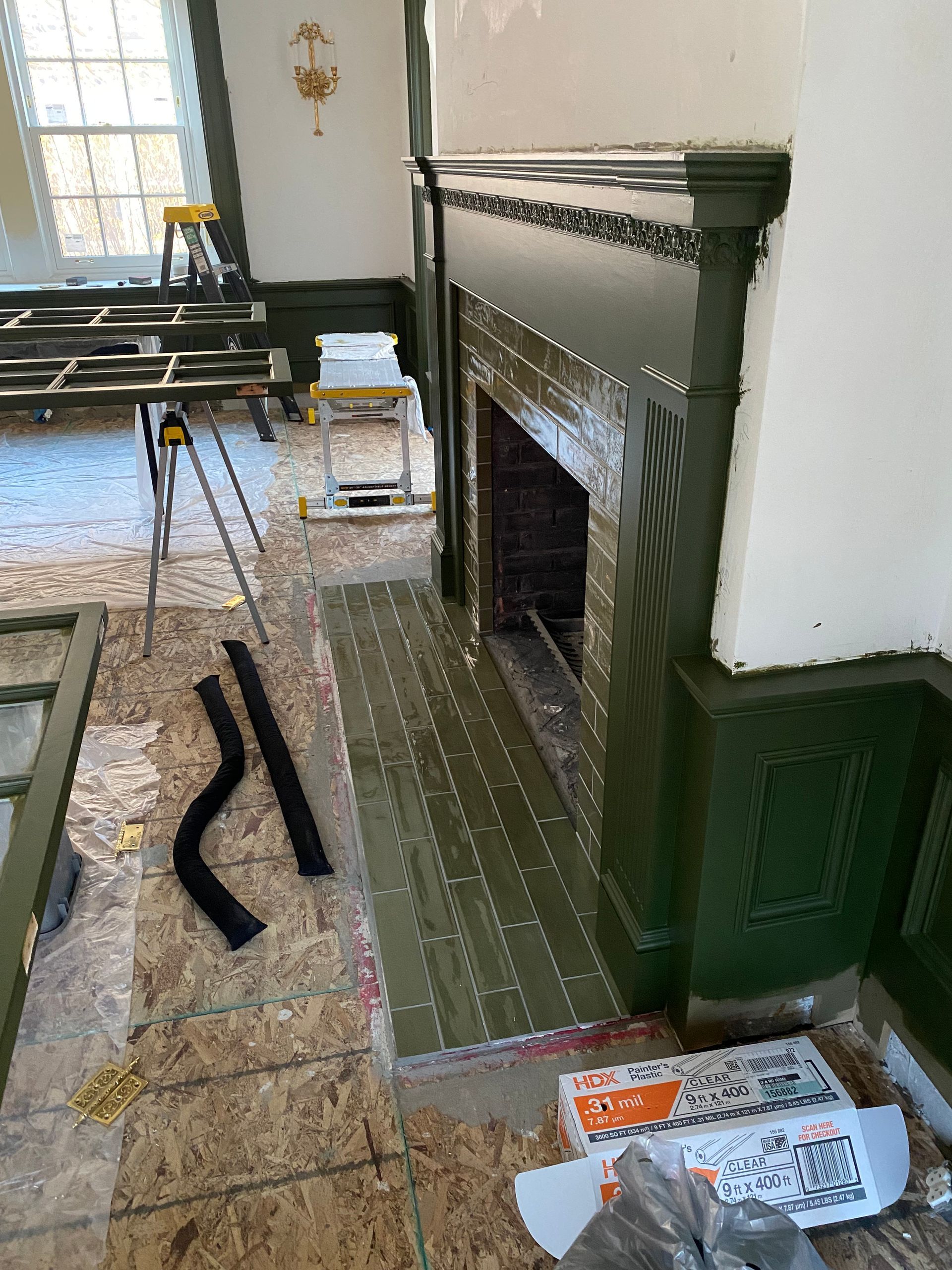 A fireplace is being remodeled in a living room.