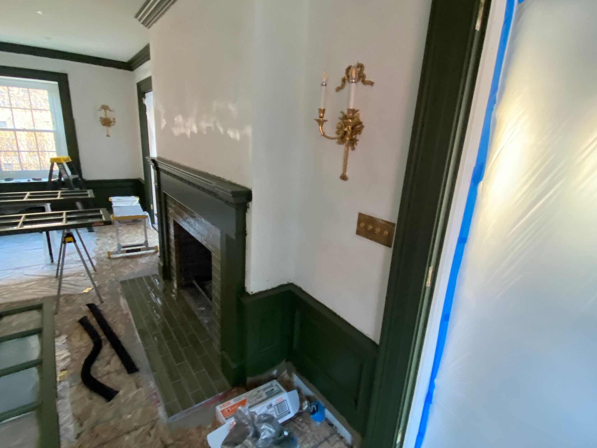 A room with a fireplace and a ladder in it