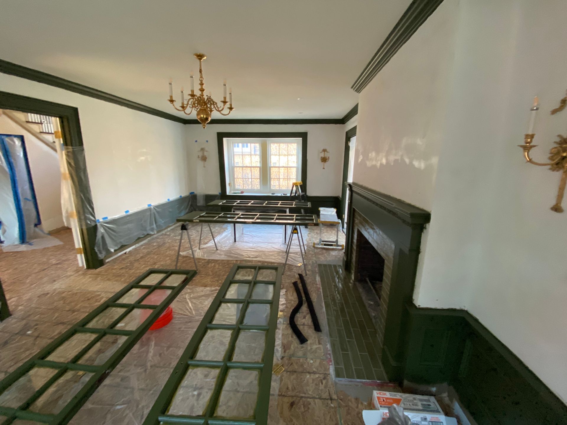 A living room with a fireplace and a chandelier.