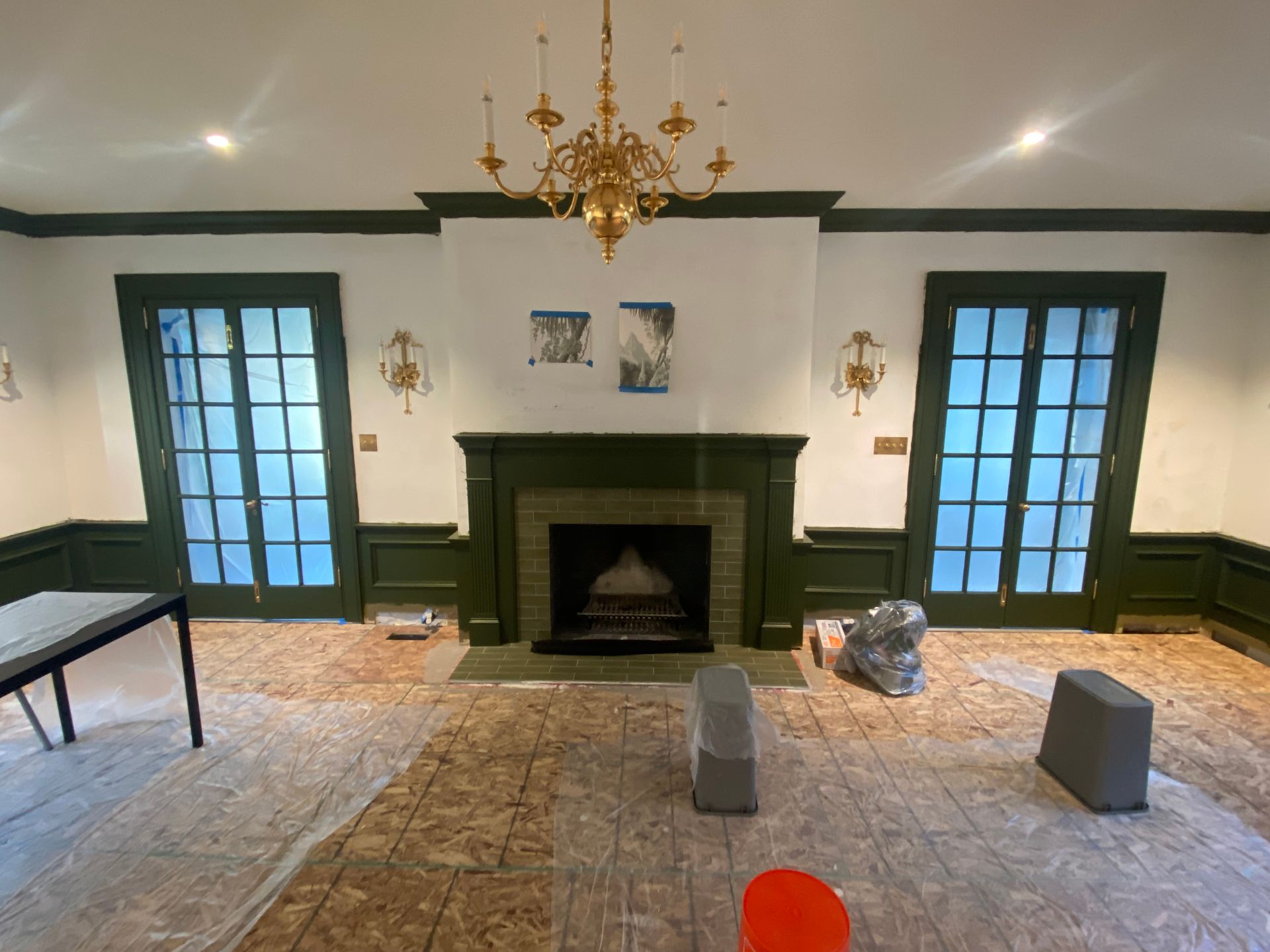 A living room with a fireplace and a chandelier