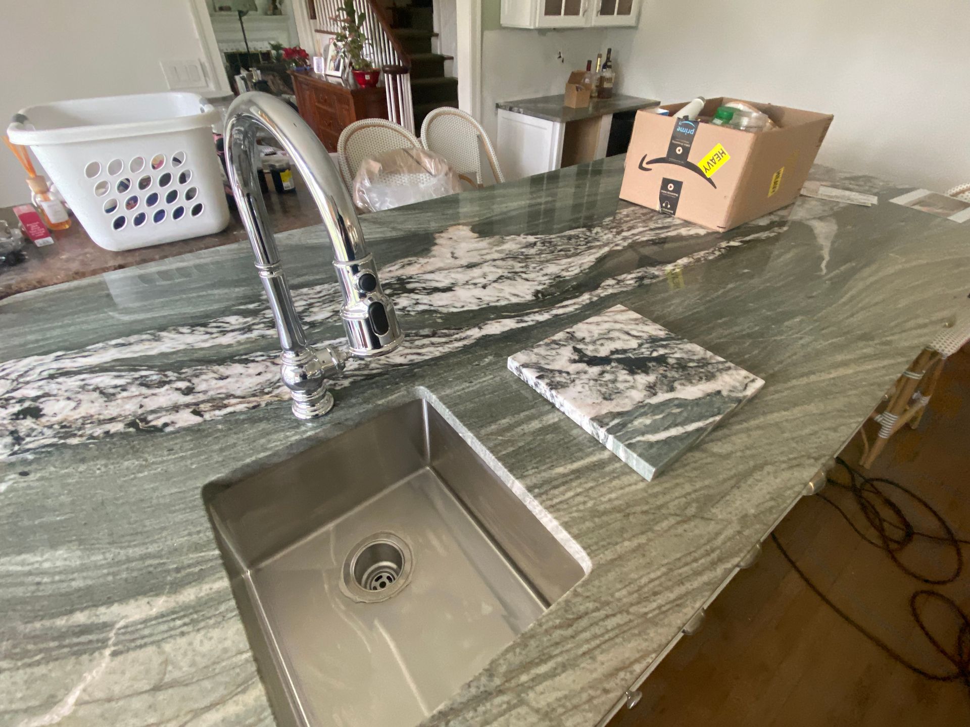 A kitchen with a stainless steel sink and a faucet.