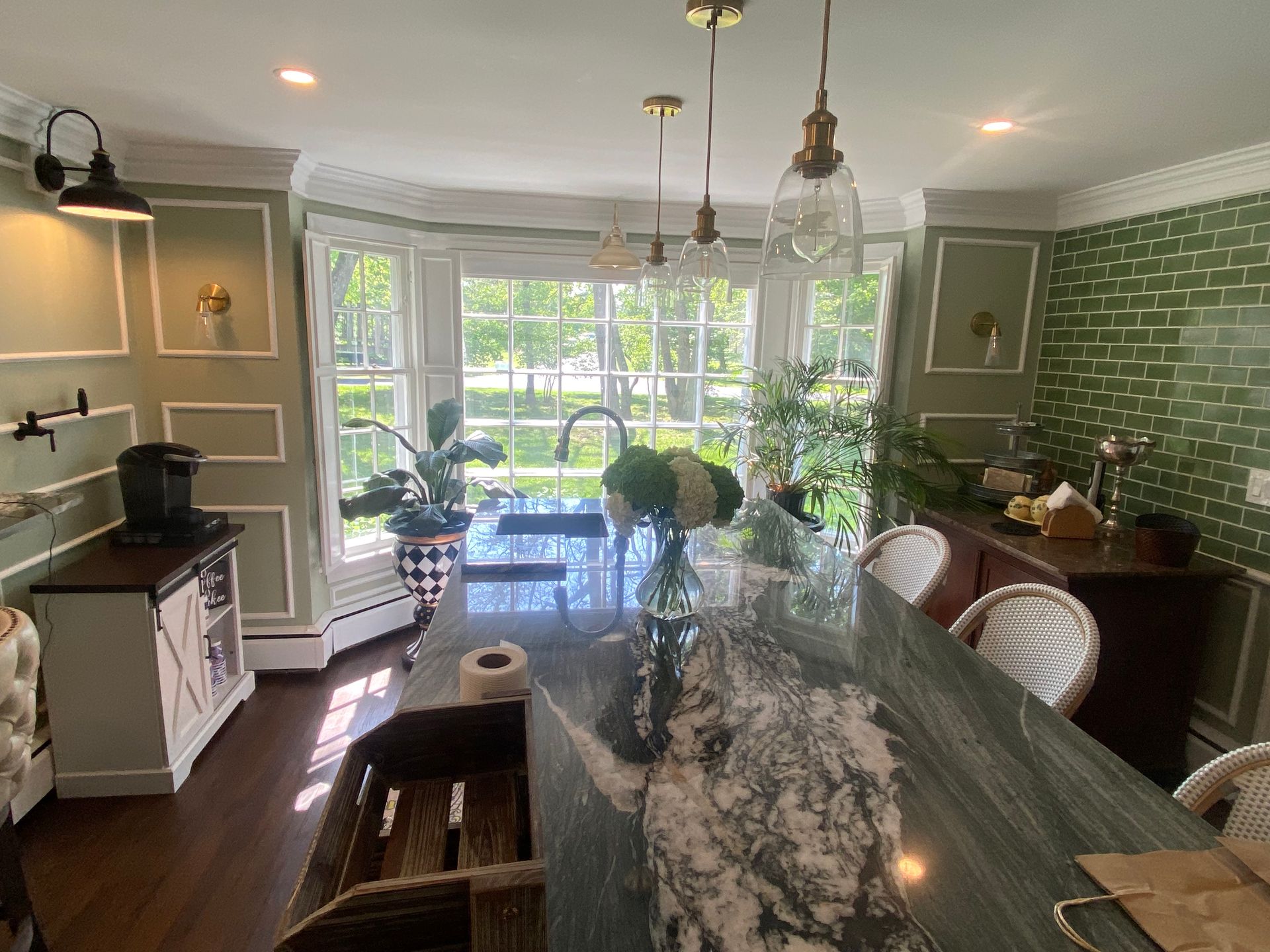 A kitchen with a large island and a large window.