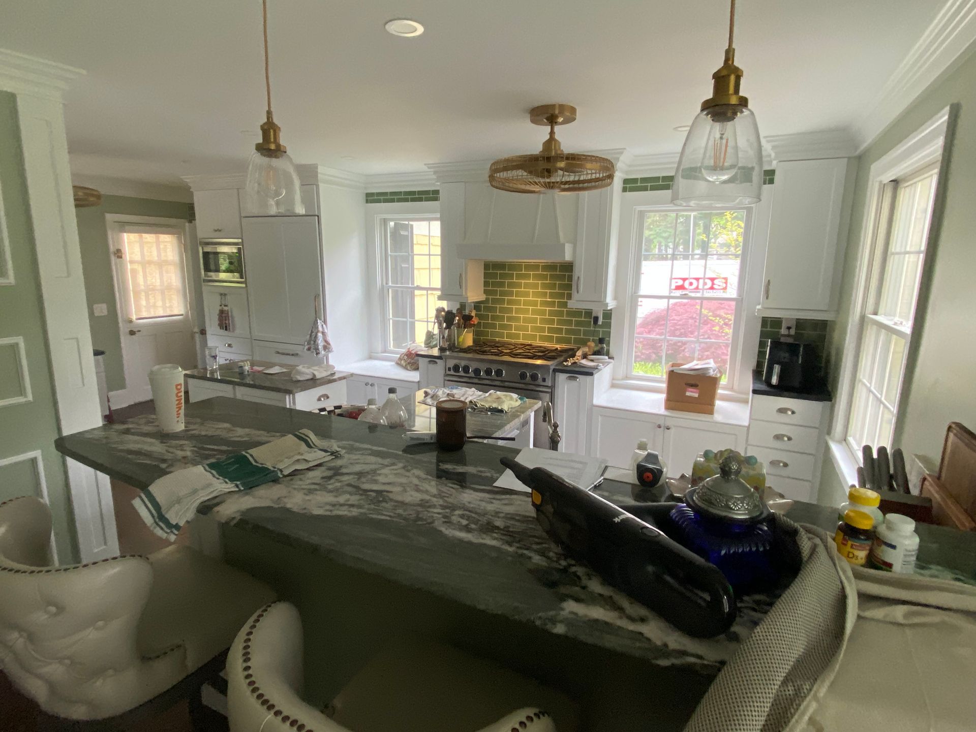 A kitchen with a large island and a stove.