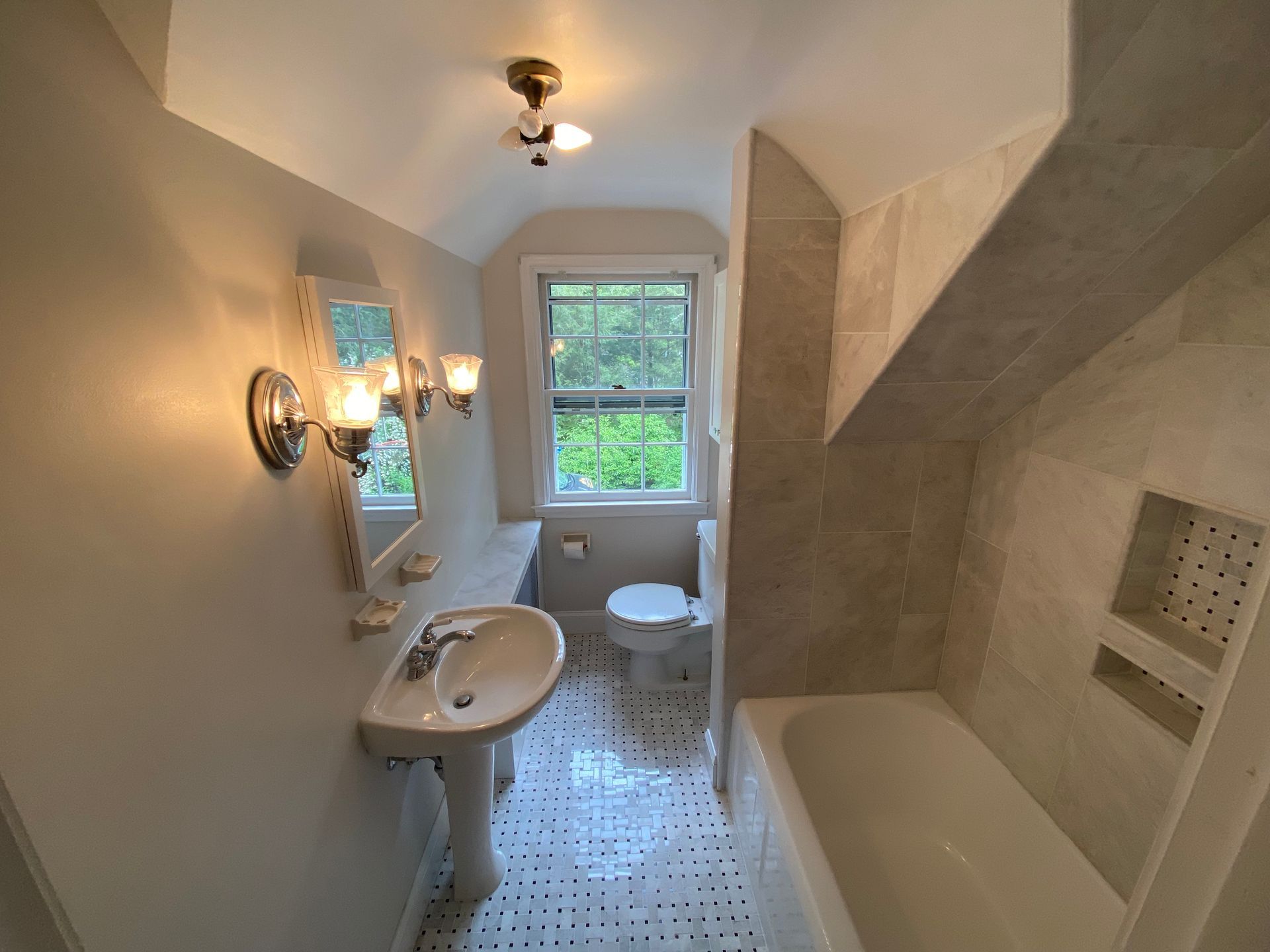 A bathroom with a sink a toilet and a bathtub