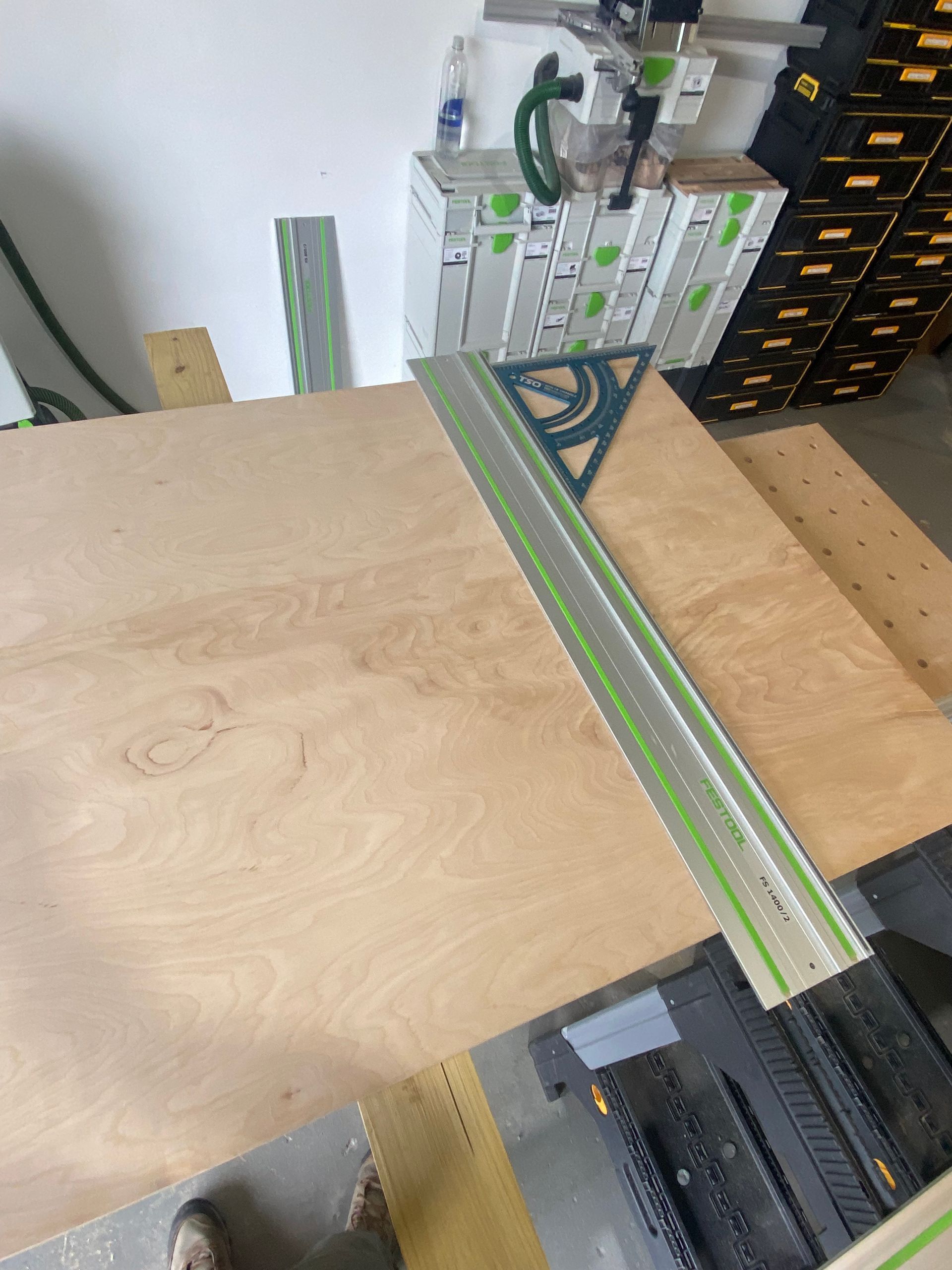 A person is cutting a piece of wood with a circular saw