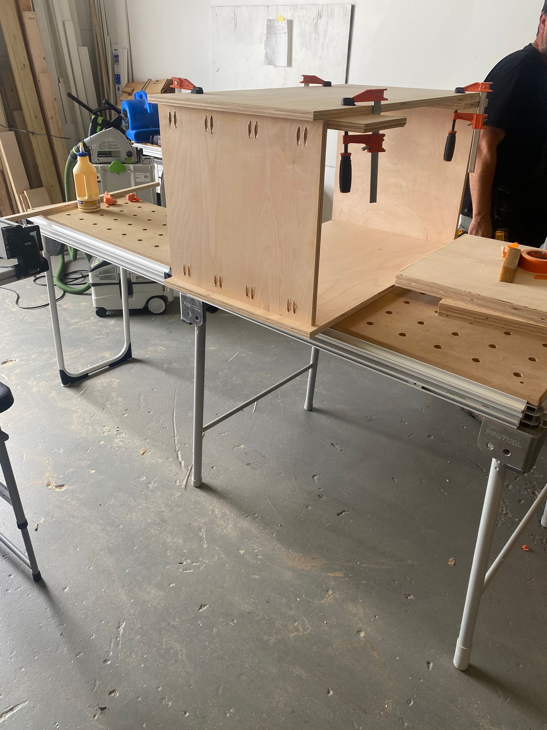 A man is working on a piece of wood on a table