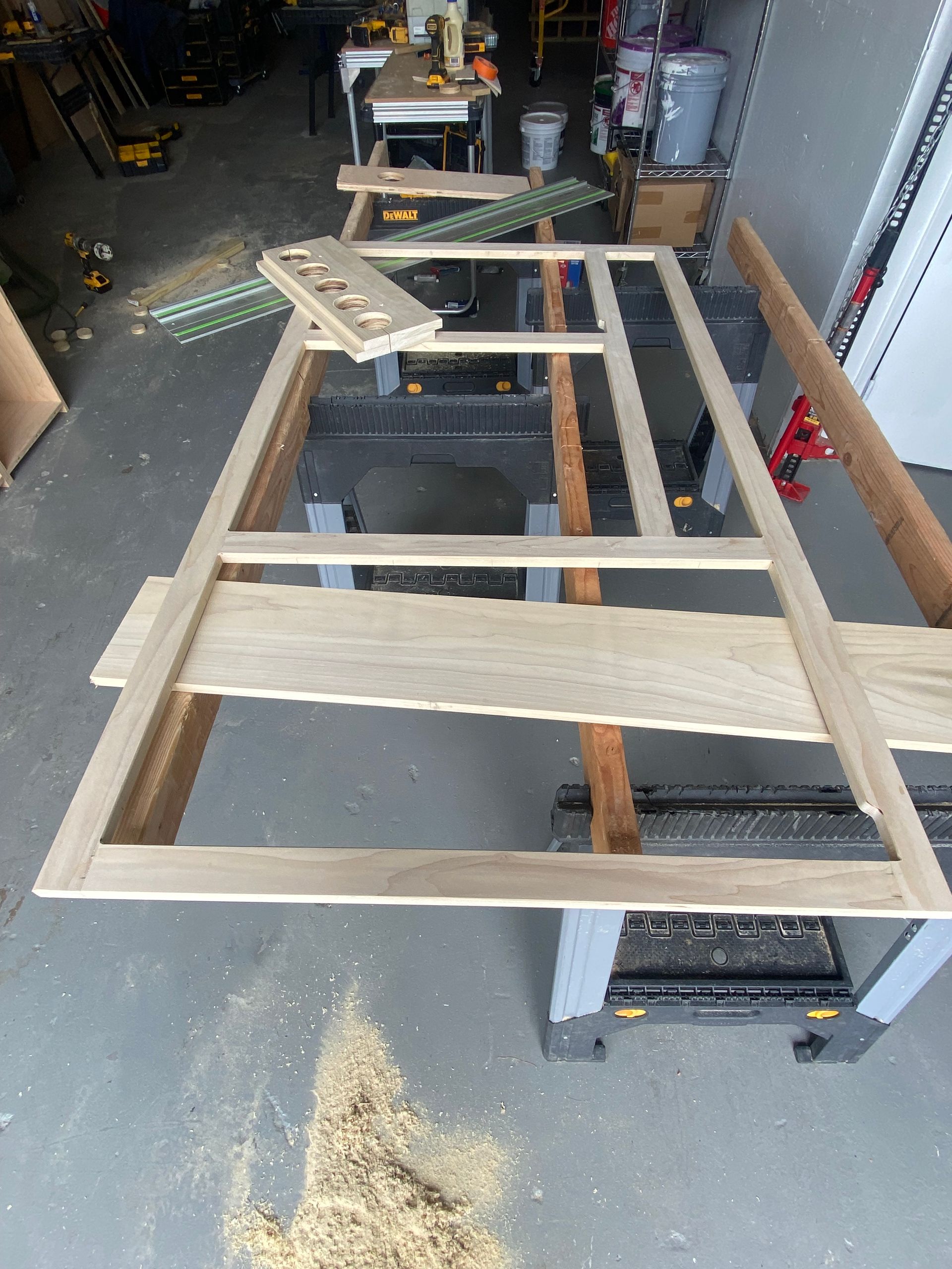 A piece of wood is sitting on top of a table in a garage.