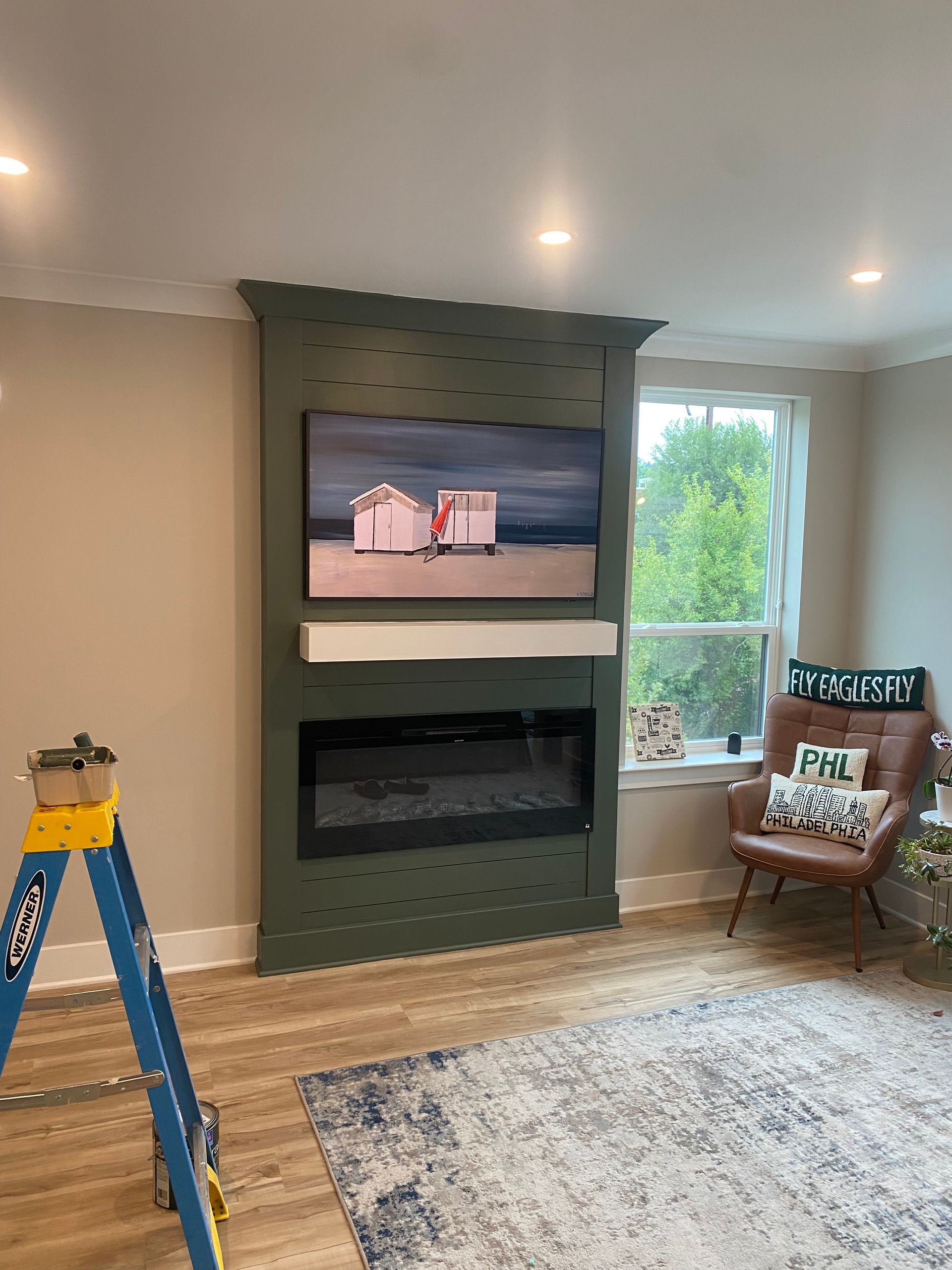 A living room with a fireplace and a flat screen tv
