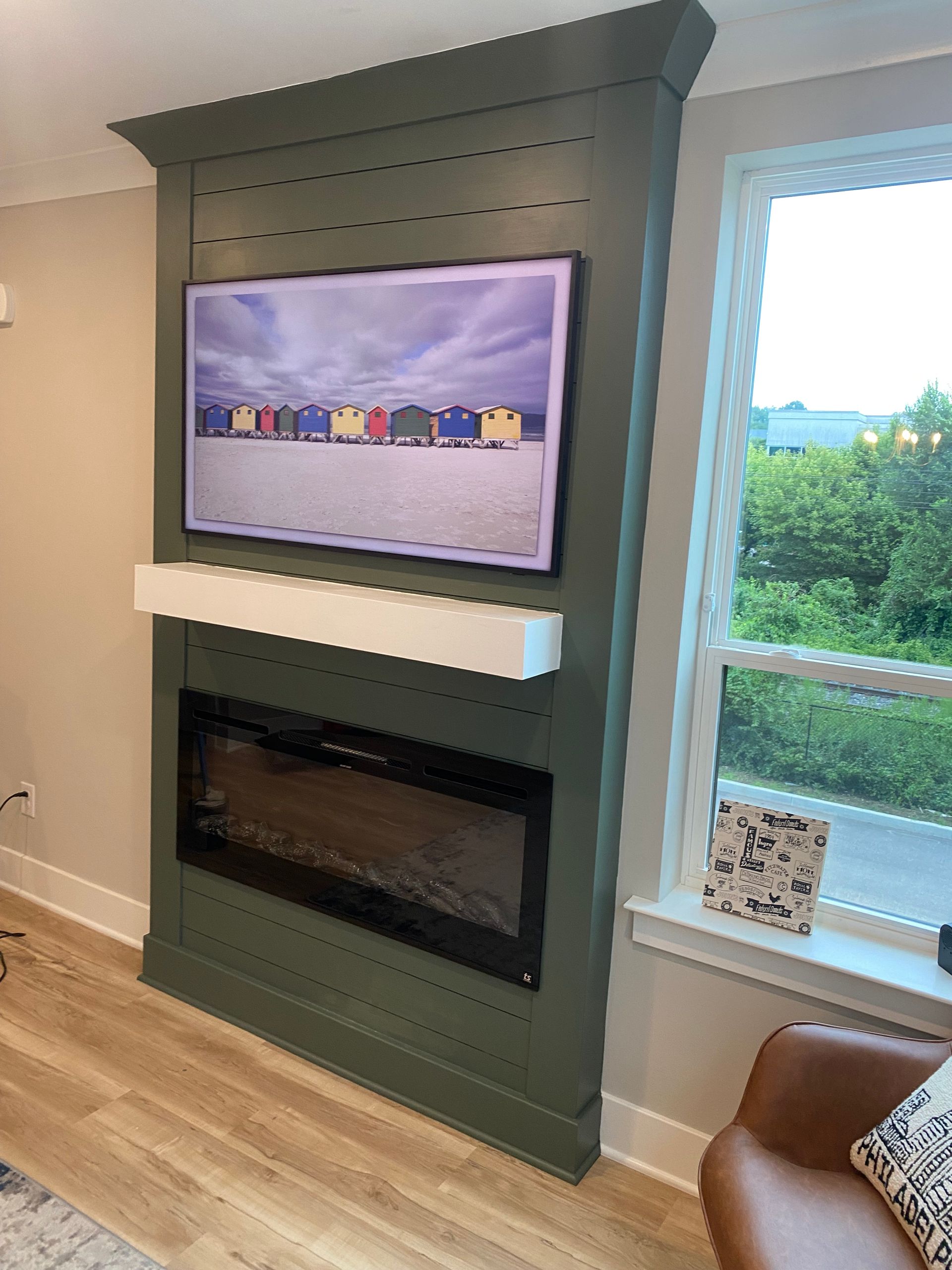 A living room with a fireplace and a flat screen tv