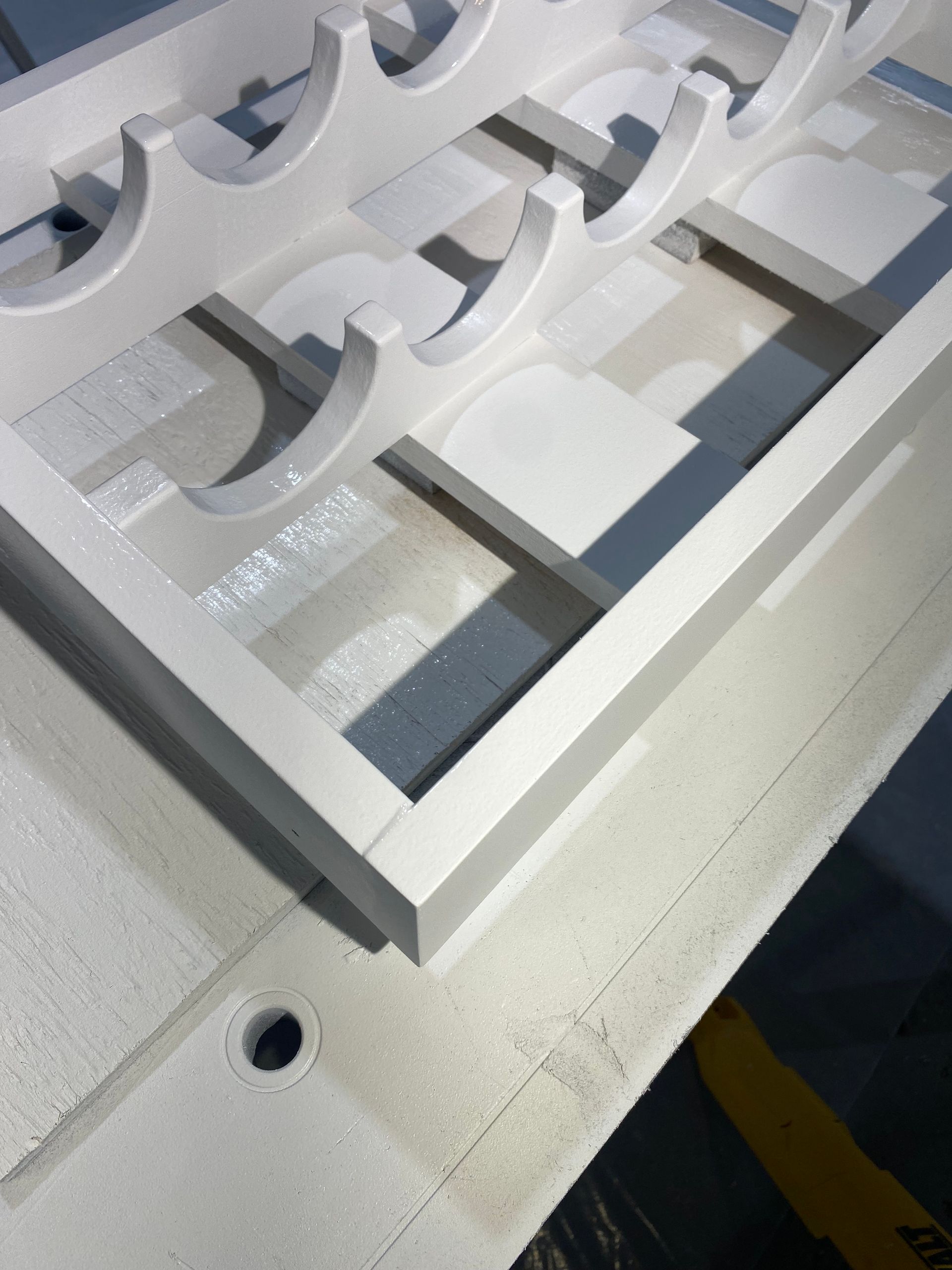 A white shelf with a hole in the middle of it