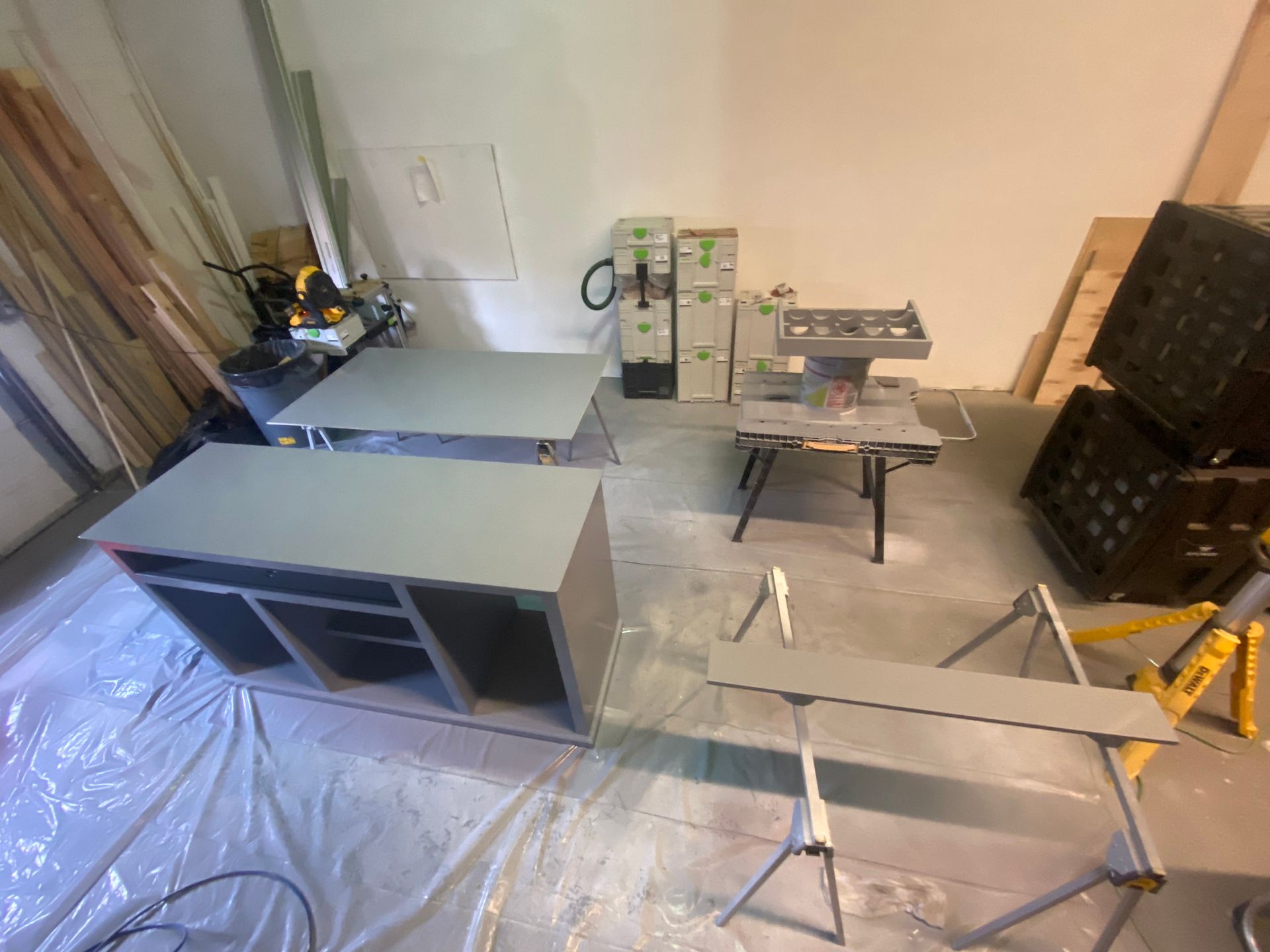 A room with a lot of tables and boxes on the floor.