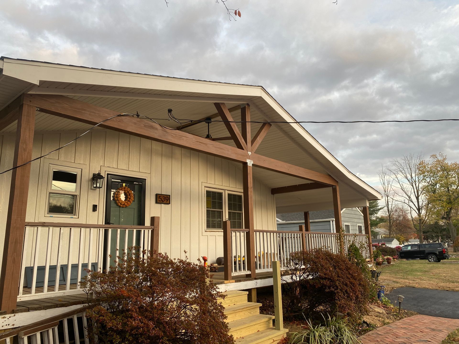 A white house with a large porch and stairs