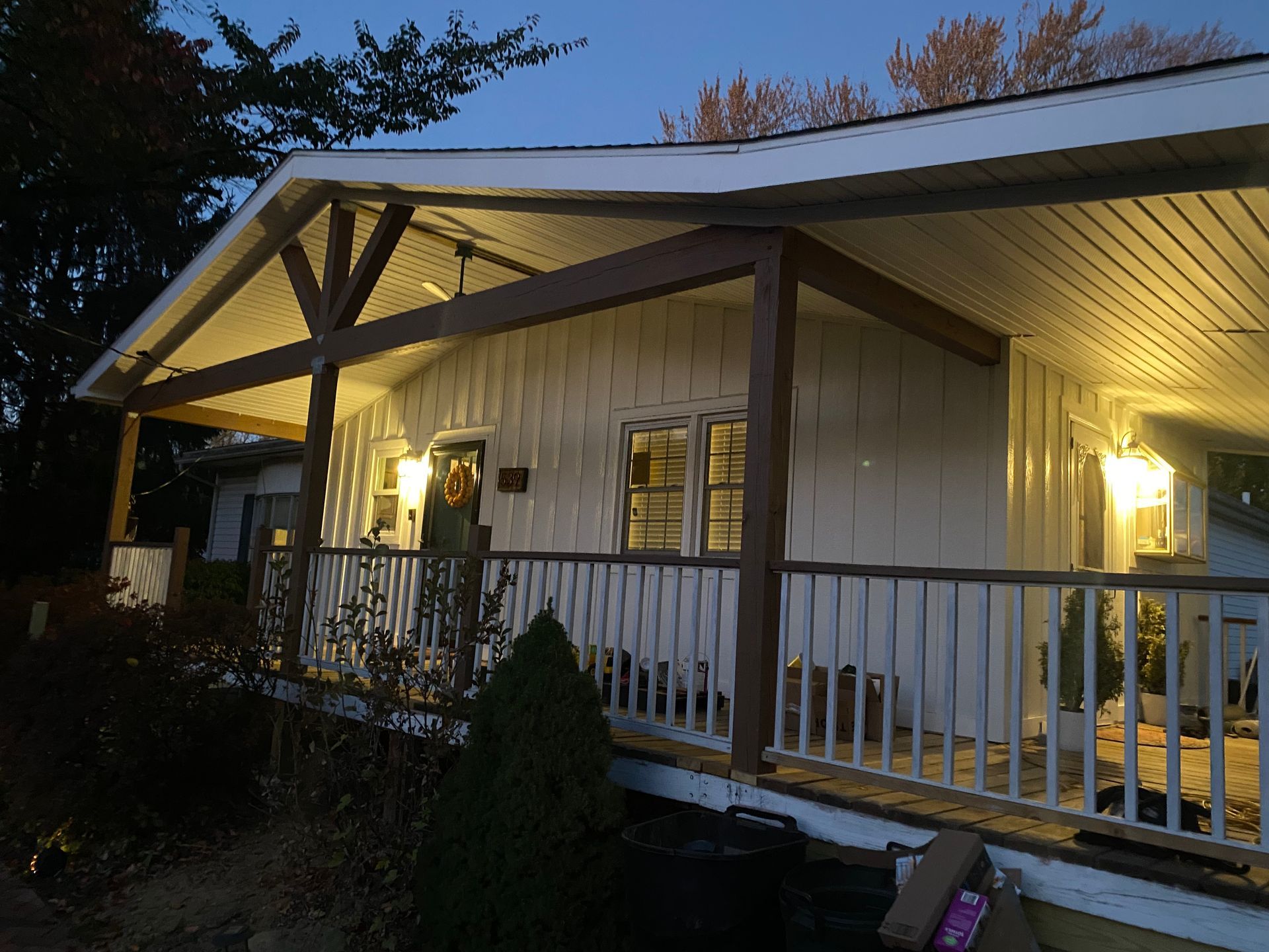 A house with a porch that is lit up at night