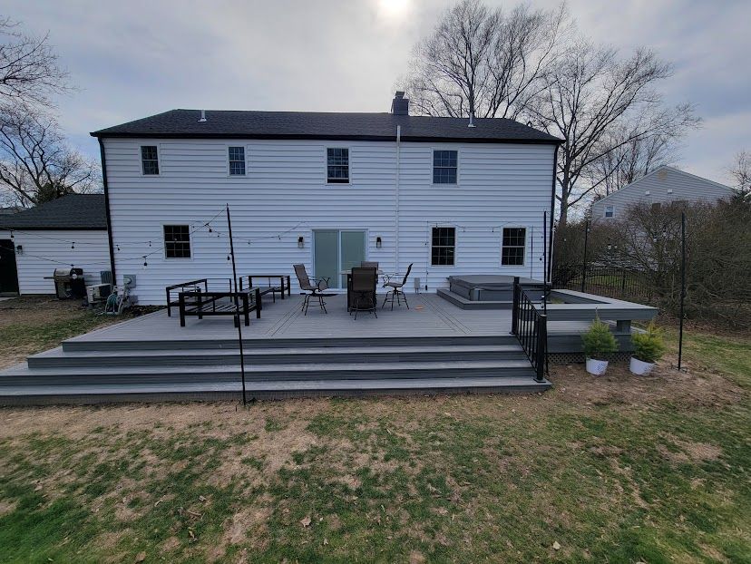 A large white house with a large patio in front of it.