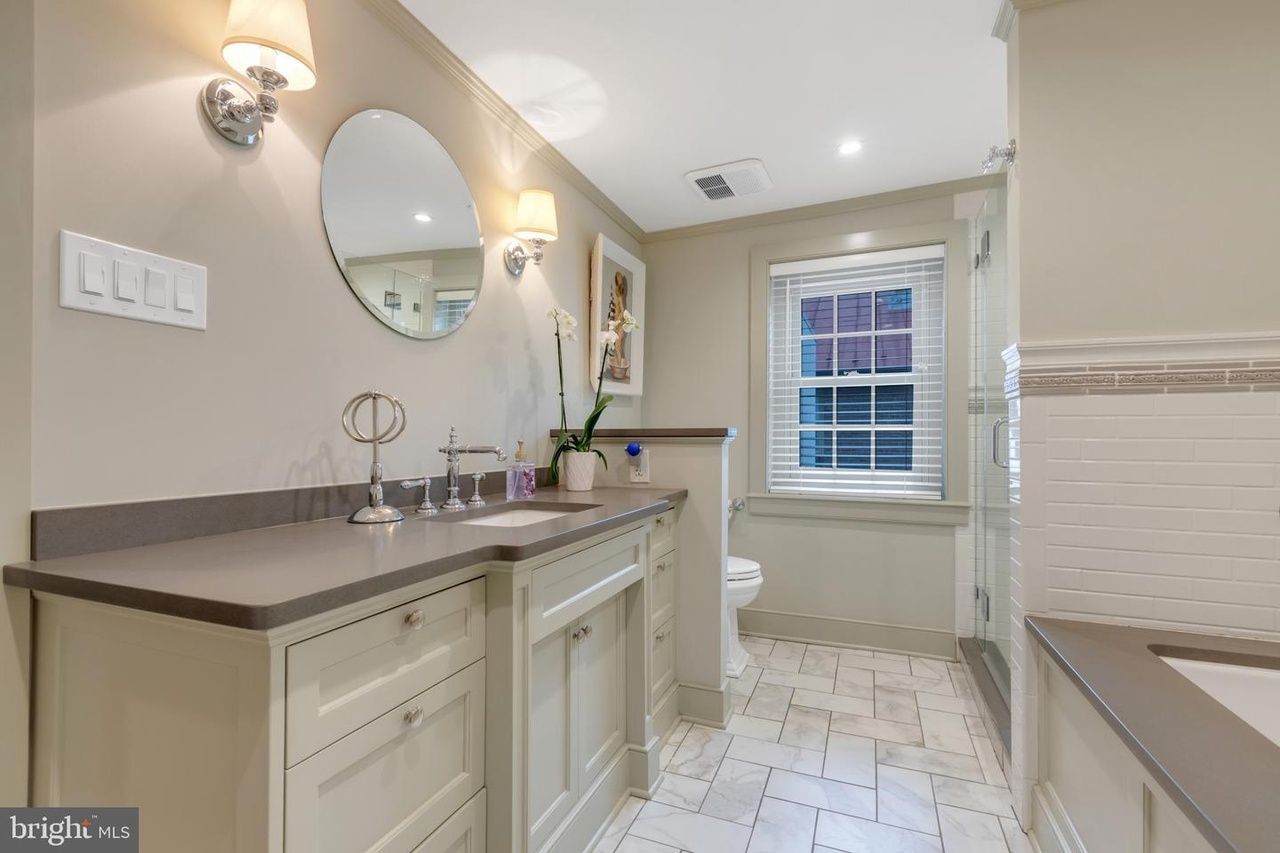 A bathroom with a sink , toilet , and mirror.