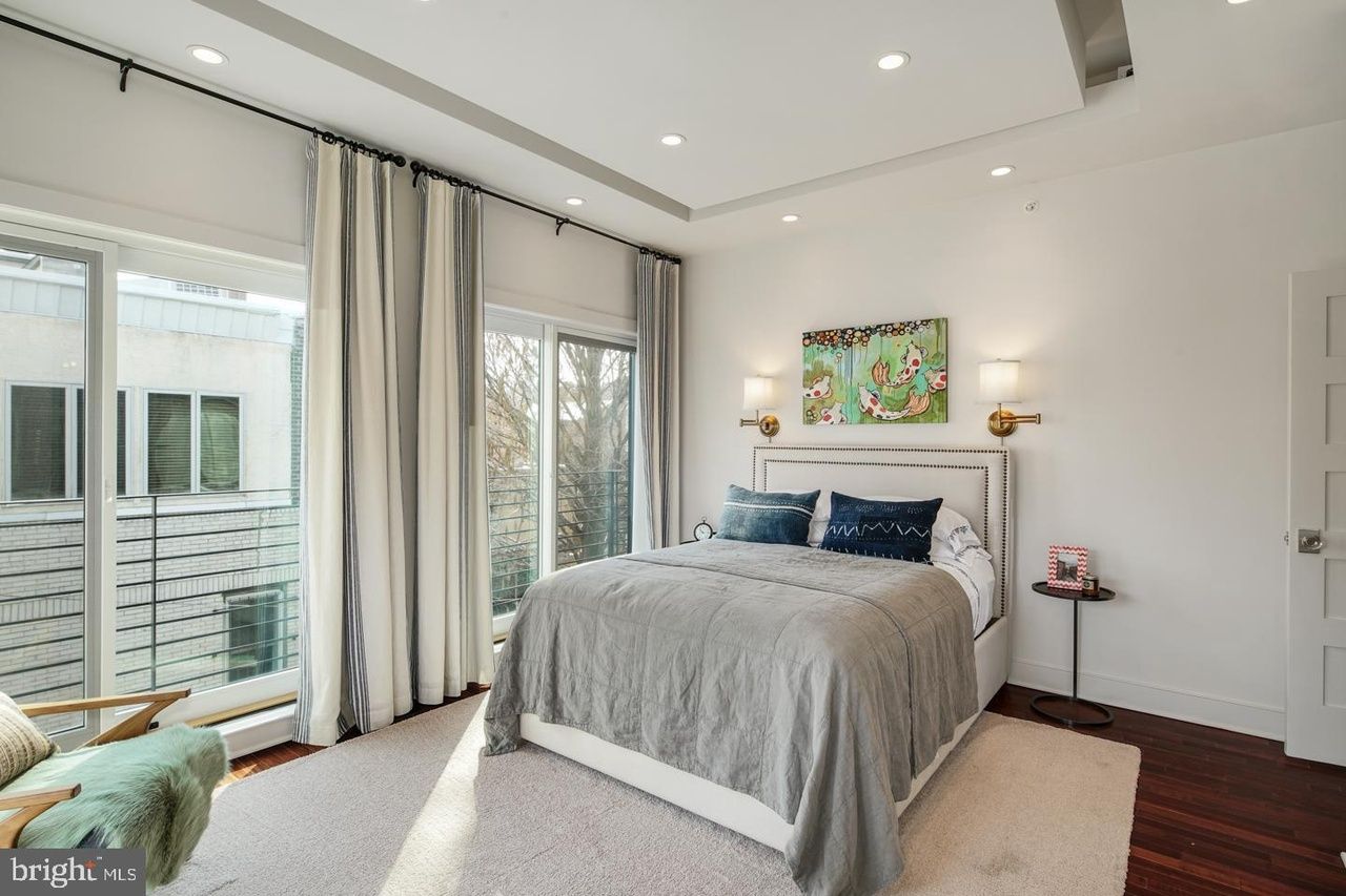 A bedroom with a large bed and a large window