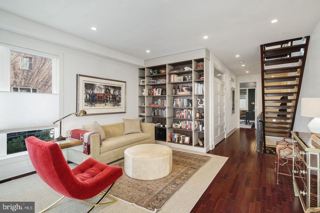 A living room with a couch and a red chair