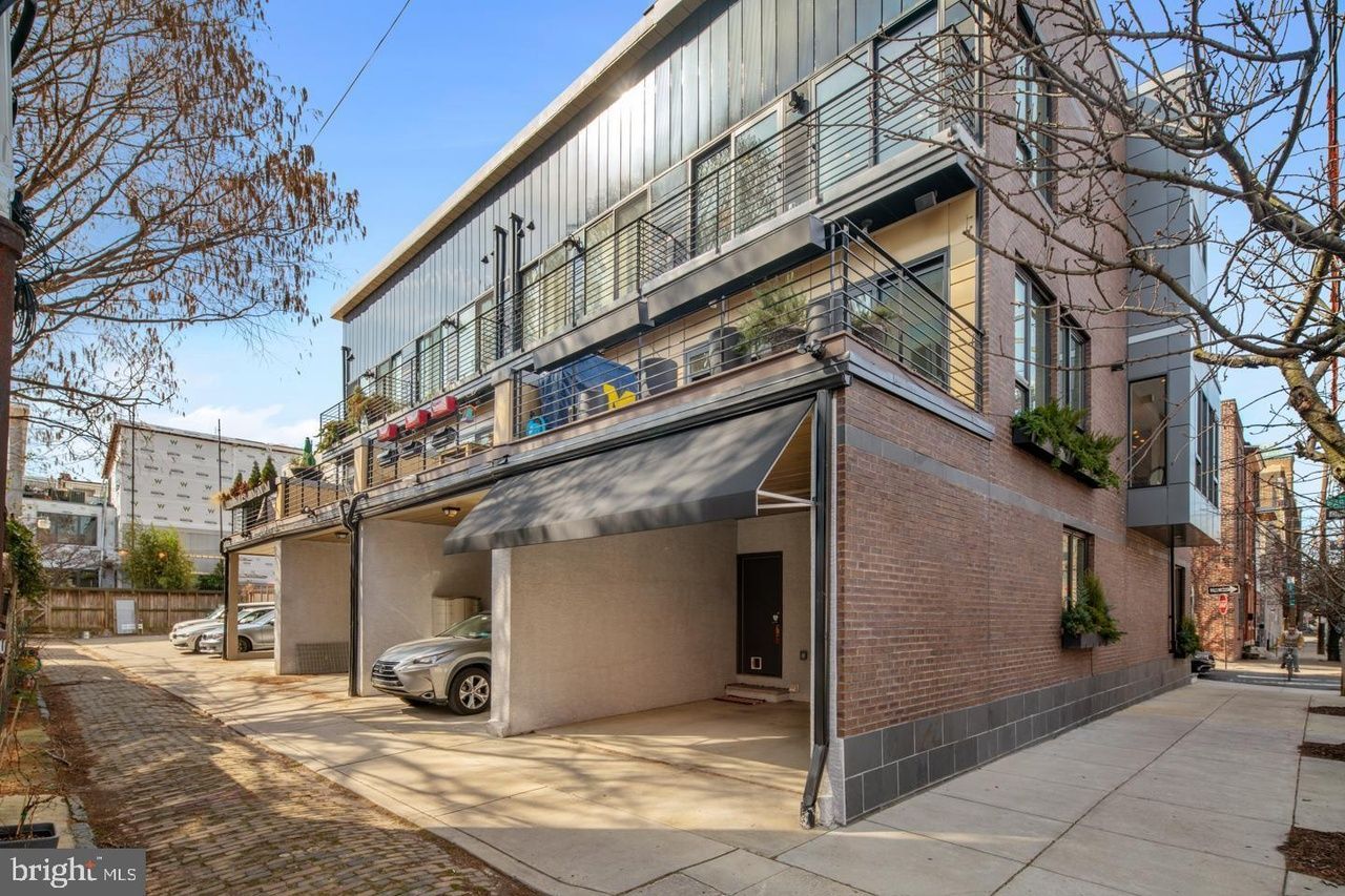 A brick building with a car parked in front of it.