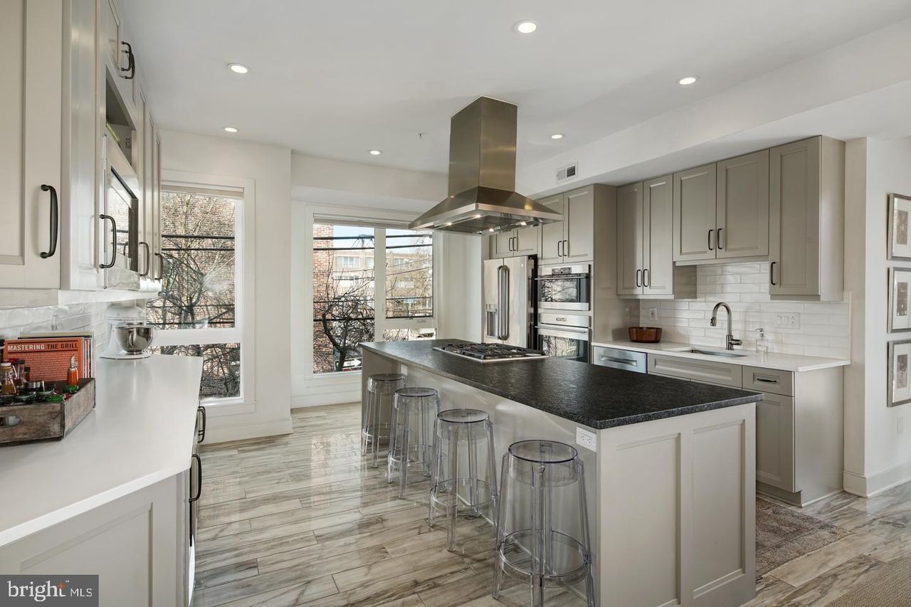 A kitchen with a large island in the middle of it.