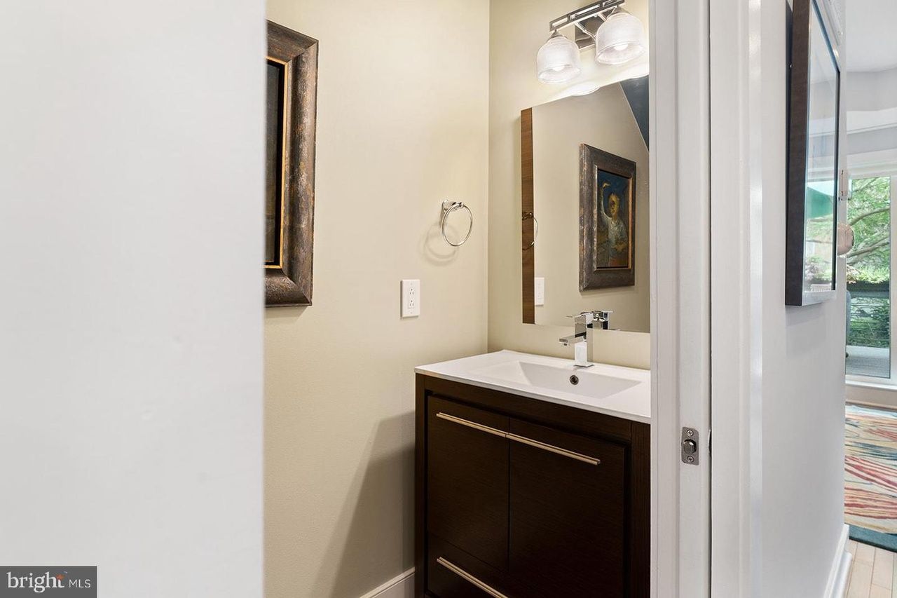 There is a bathroom with a sink and a mirror.