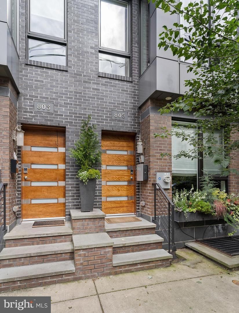 The front of a brick building with two wooden doors