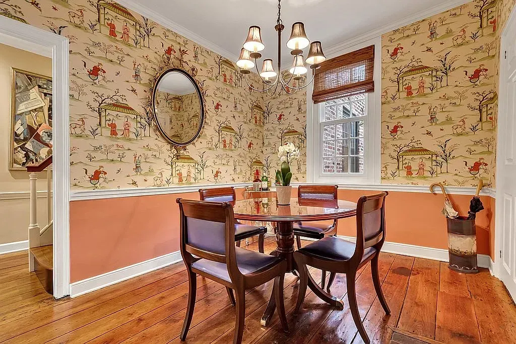 A dining room with a table and chairs and a chandelier.