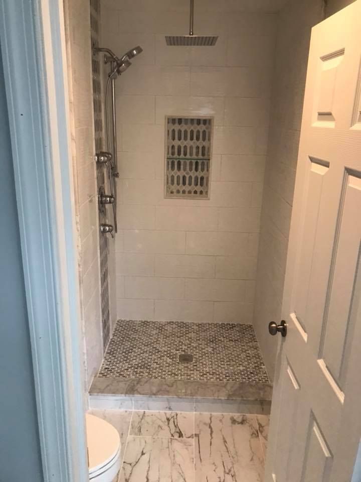 A bathroom with a walk in shower and a toilet.