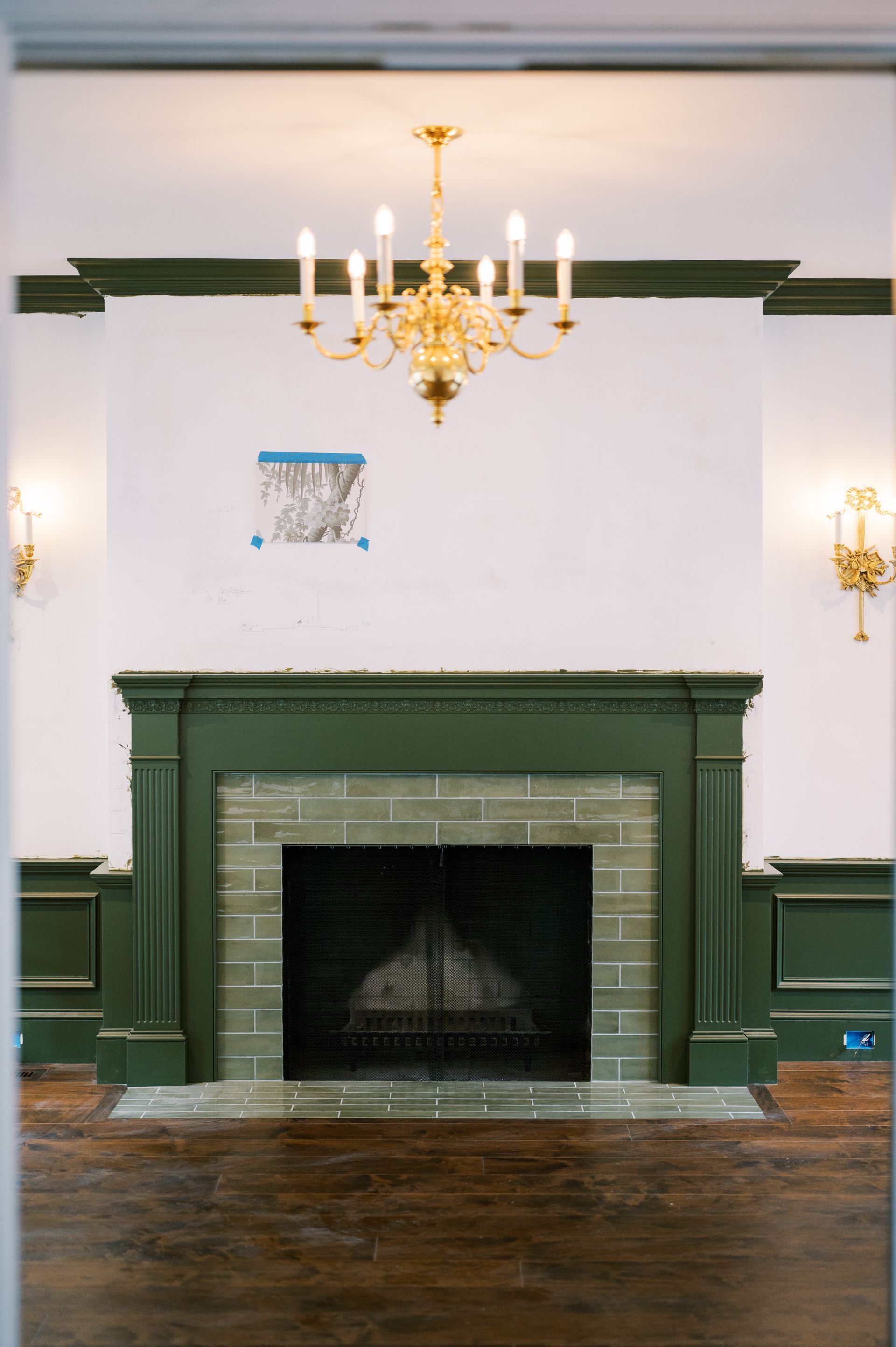 A living room with a fireplace and a chandelier