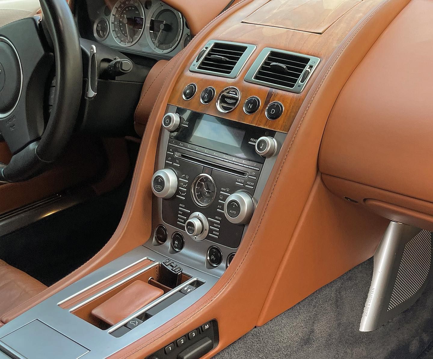 the dashboard of a car has a steering wheel and a radio