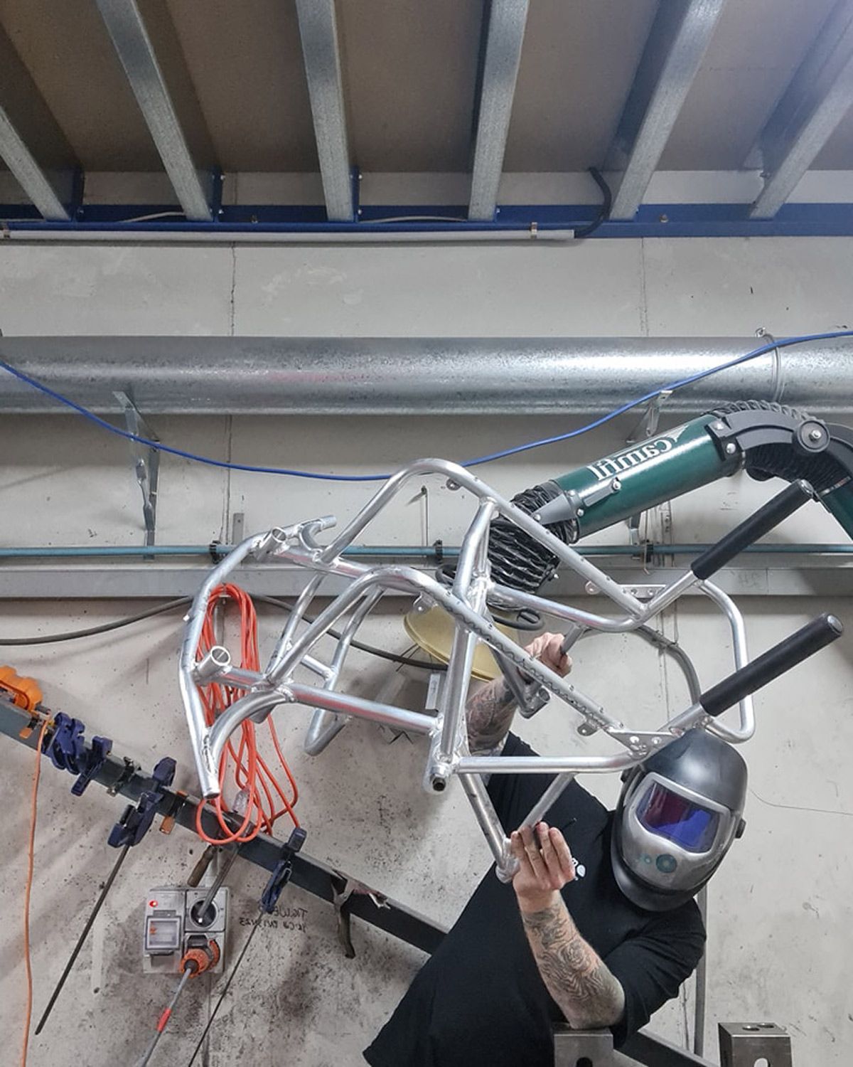 Man Working On A Frame For A Custom Wheelchair — Mogo Wheelchairs In Bankstown, NSW