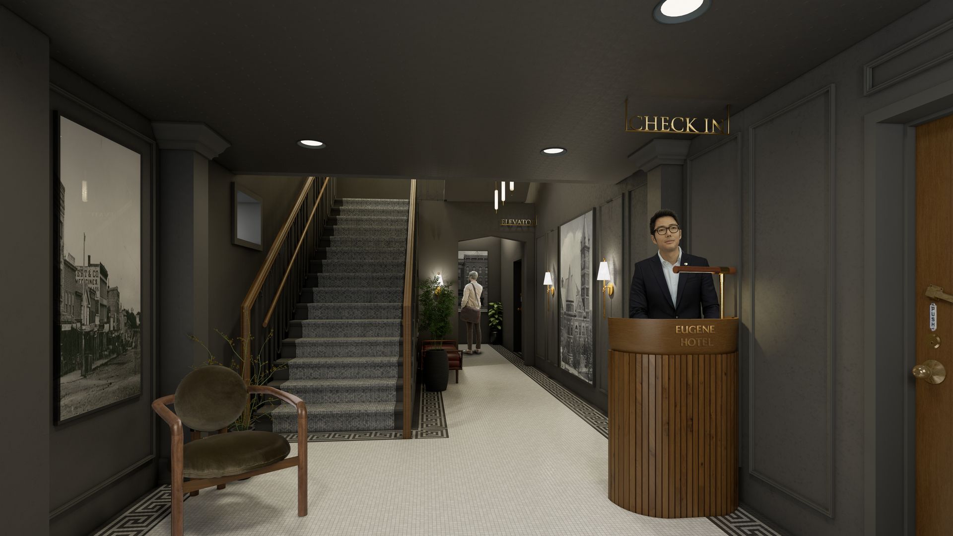 A receptionist stands at a dark wooden desk in a modern hotel lobby, near a staircase and art-lined walls.