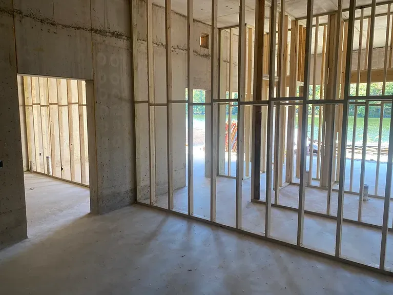 An empty room with a lot of wooden walls and a window.