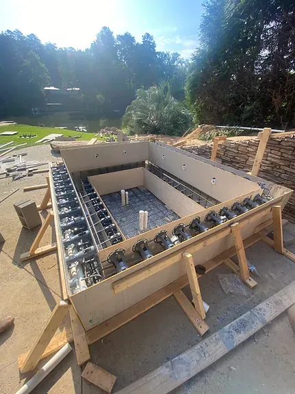 A large wooden box is sitting on top of a concrete surface.