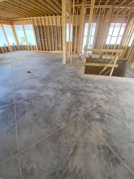 A large concrete floor in a building under construction.