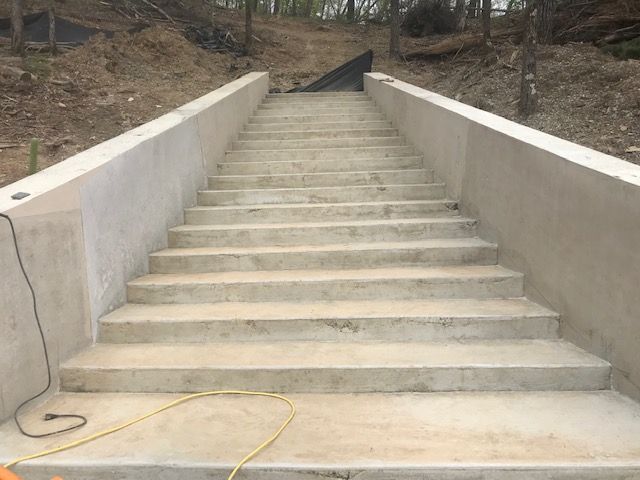 A set of concrete stairs going up a hill.