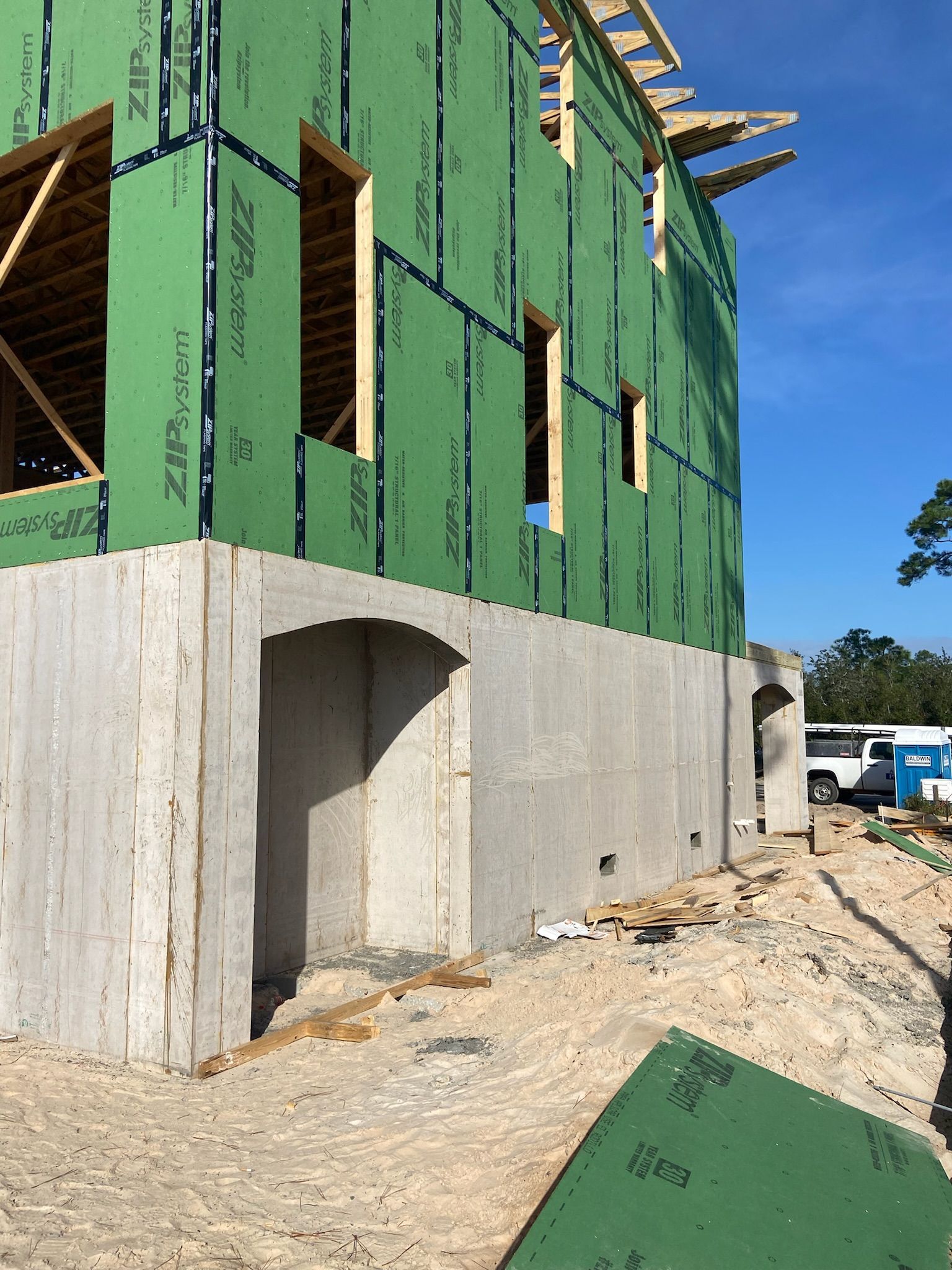 A building is being built with green insulation on the walls.