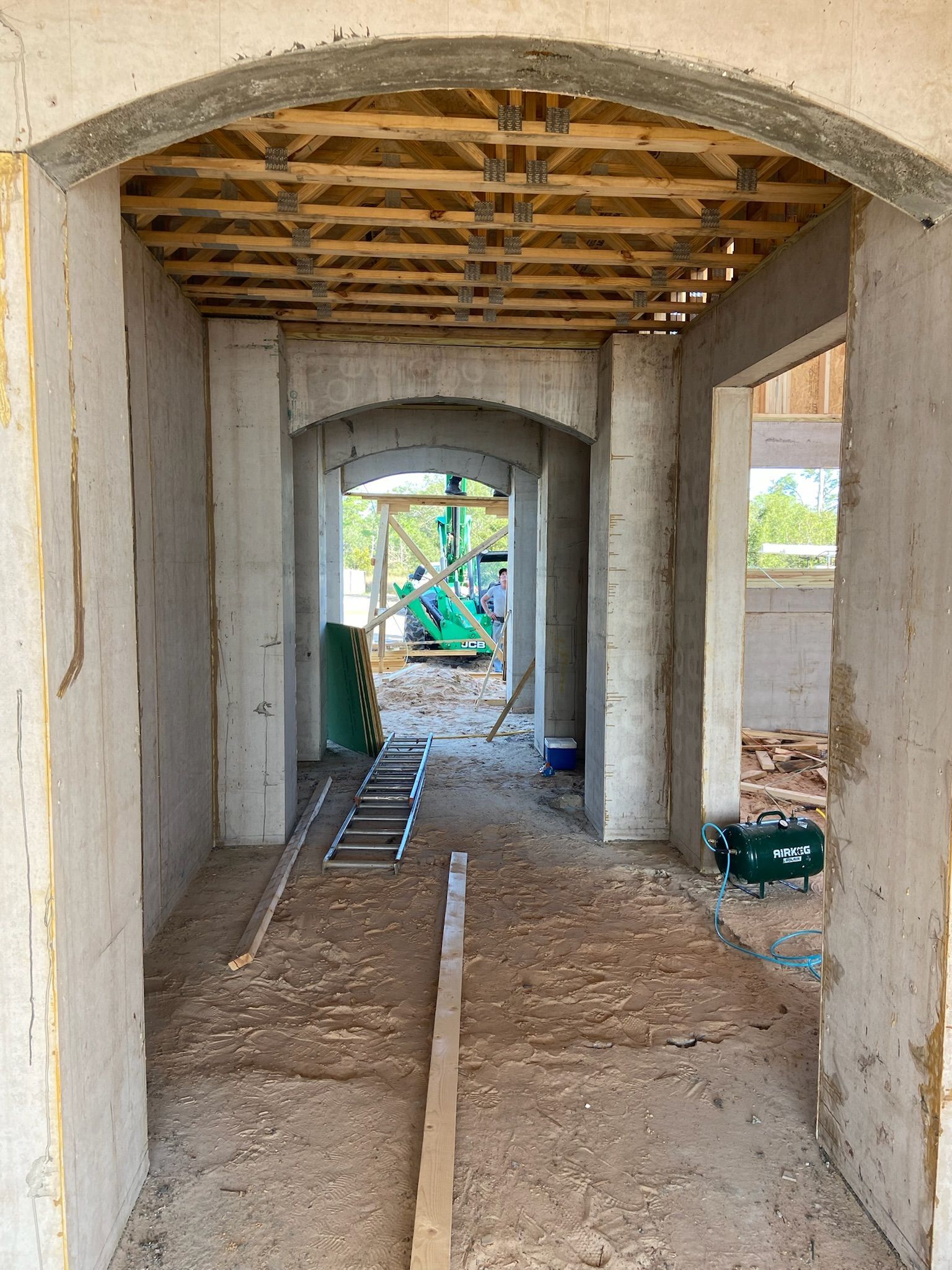 A hallway in a building under construction with a ladder on the floor.