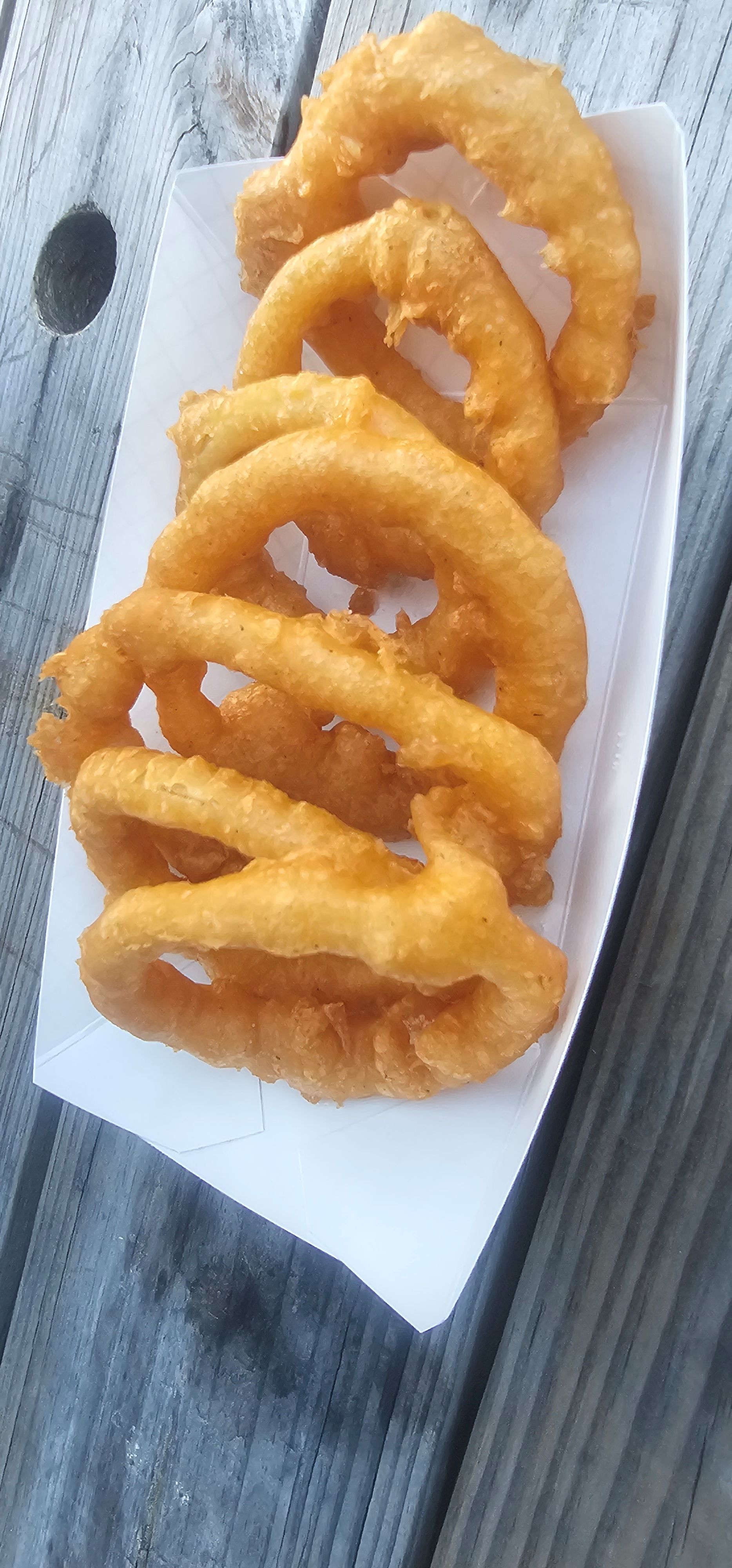 Onions rings on tray.