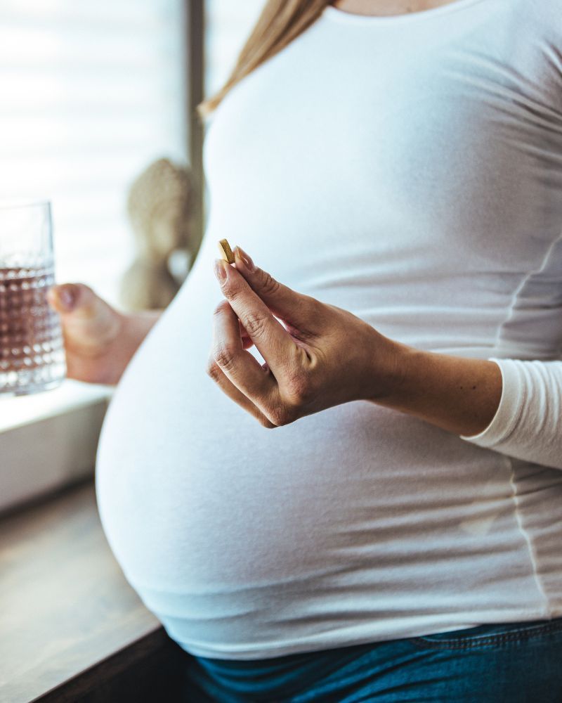 Pregnant woman takes a vitamin B12 (folic acid) supplement
