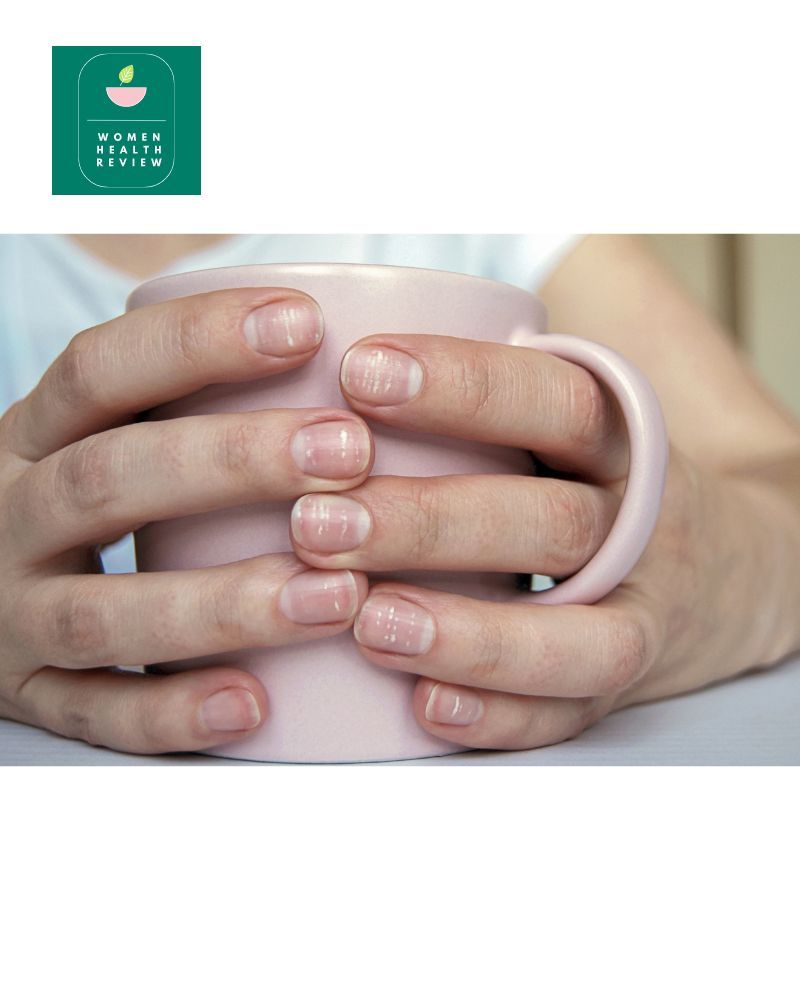Women's hands holding a pink cup