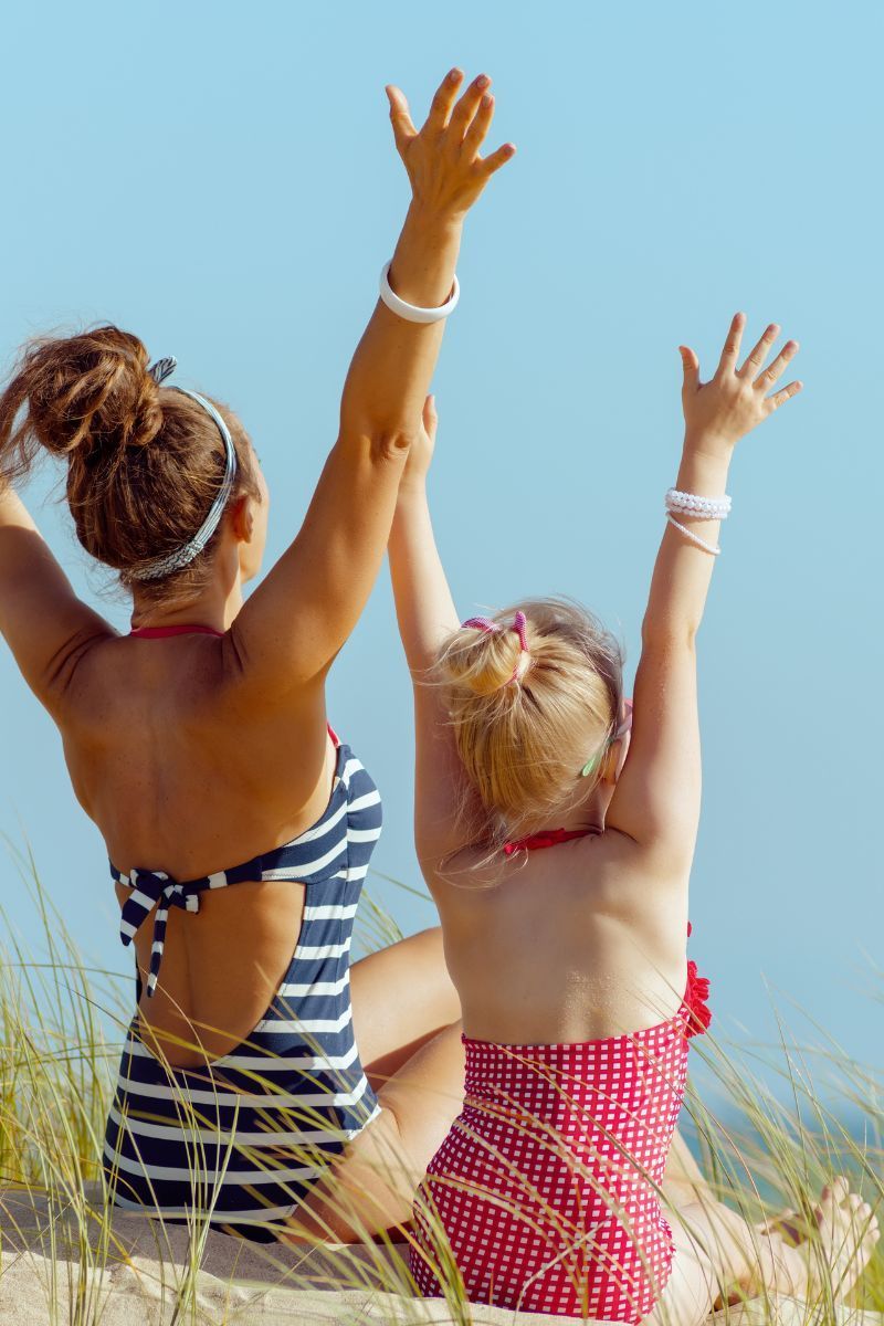 Mom and daughter facing sun