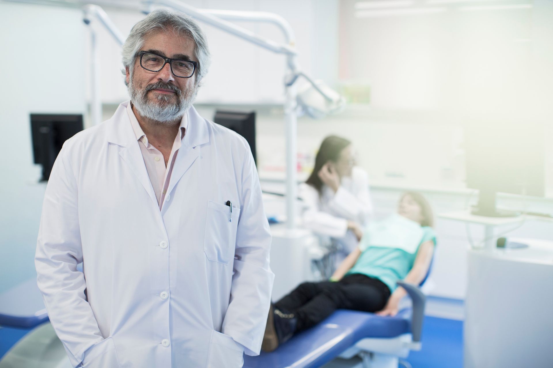 Confident emergency dentist ready to help, smiling at the camera Confident emergency dentist ready to help, smiling at the camera