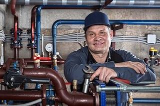Plumber Holding Wrench - Pump Contractor in Batavia, IL