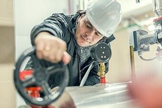 Plumber Inspecting Valve - Pump Contractor in Batavia, IL