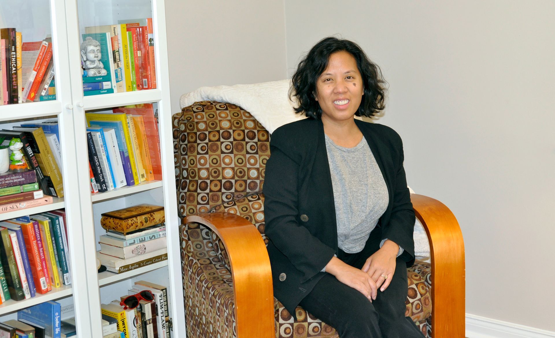 Two men in bed, one kissing the other's forehead.