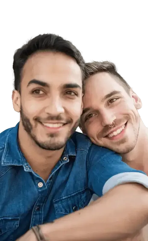 Two smiling people in a close embrace.