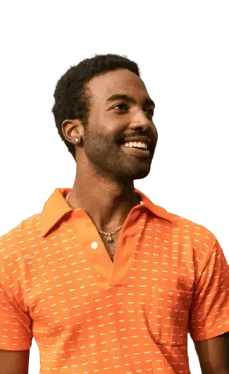 Man in orange polo shirt smiles, looking to the side.