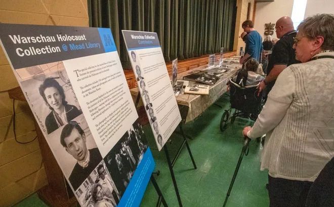 A group of people are looking at a display of warschau valiant collection.